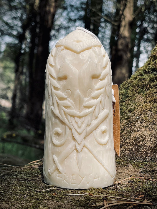 Back side of Freya candle featuring carved Nordic runes in natural light