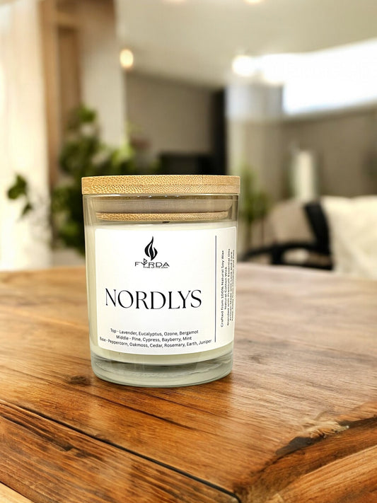 Nordlys candle by Fyrda on rustic wooden table in warm Scandinavian-style interior