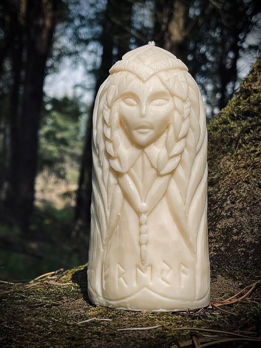 Freya pillar candle carved by hand — Norse goddess design in a forest setting